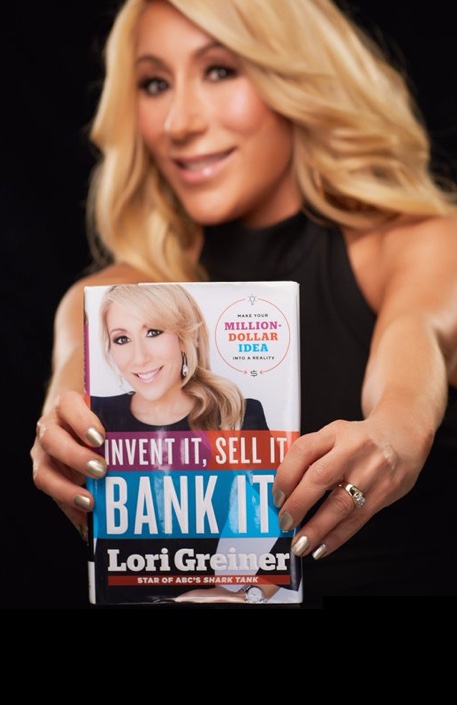 Lori holding her book,