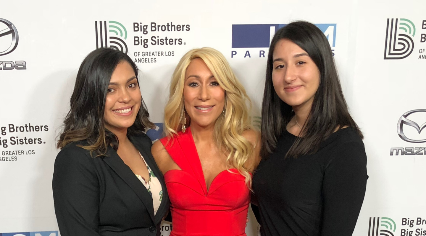 Lori at an event for Big Brothers Big Sisters with two women she mentored